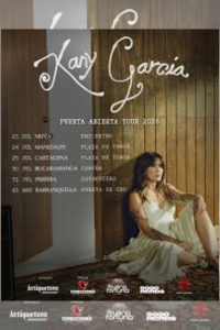 Cartel oficial de la gira 'Puerta Abierta Tour 2026' de Kany García en Colombia, detallando fechas y ciudades en Neiva, Manizales, Cartagena, Bucaramanga, Pereira y Barranquilla. Muestra a la artista sentada con un vestido blanco junto a una puerta de madera. Útil para ilustrar noticias sobre conciertos y música en Colombia.